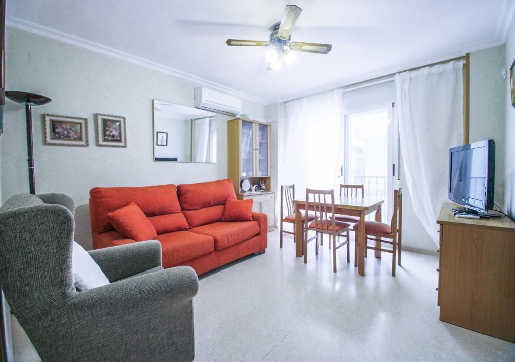 - un salon avec un canapé orange et une table dans l'établissement Santa Faz Old Town, à Benidorm