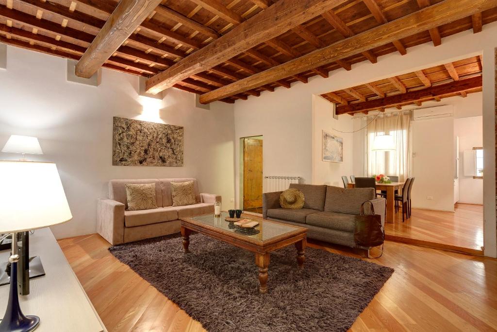 a living room with a couch and a coffee table at Mamo Florence - San Lorenzo Apartment in Florence