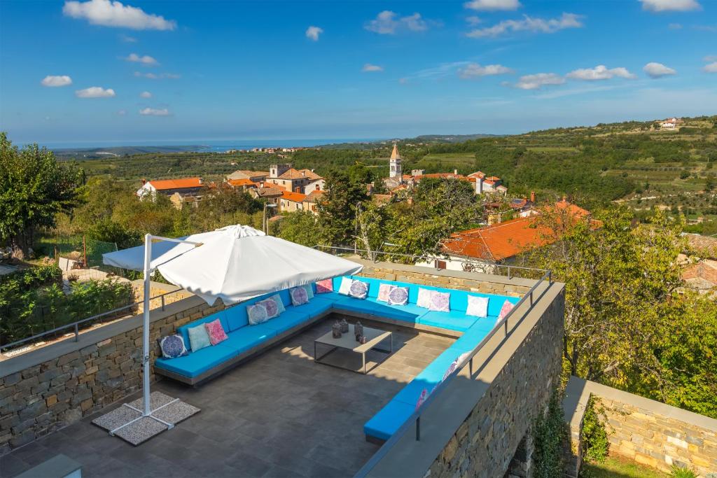 een villa met een zwembad en een parasol bij Exceptional 5 Star villa with breathtaking views, Sauna and fitness studio in Momjan