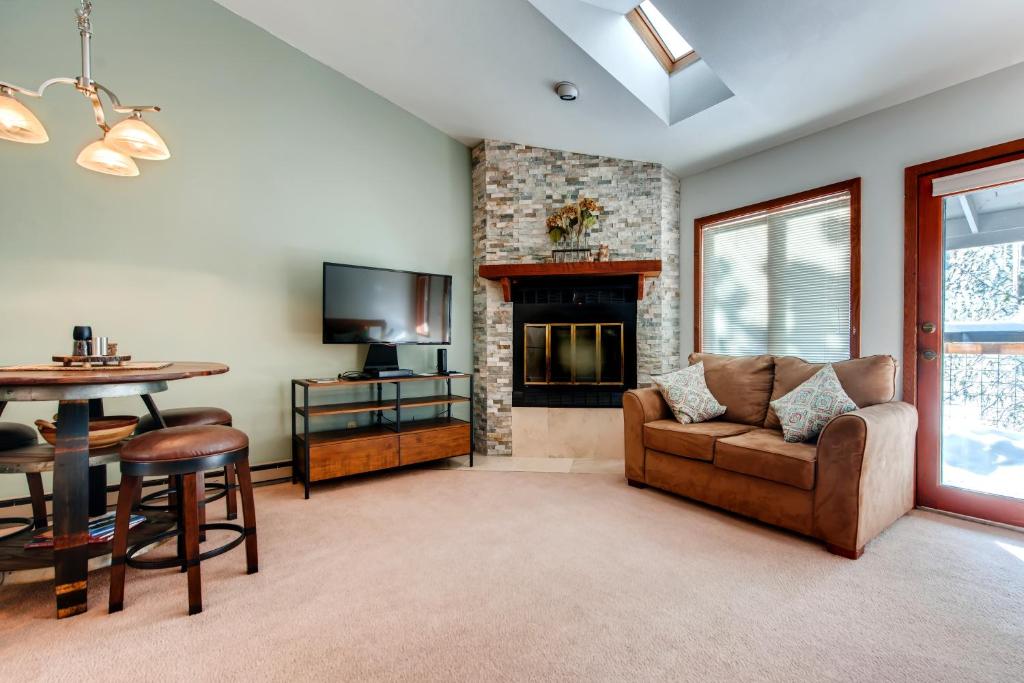 a living room with a couch and a fireplace at Mount Royal Townhome in Frisco