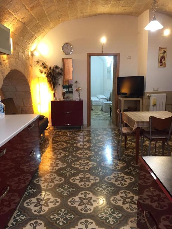 a living room with a table and a living room with a couch at Sea Home in Monopoli