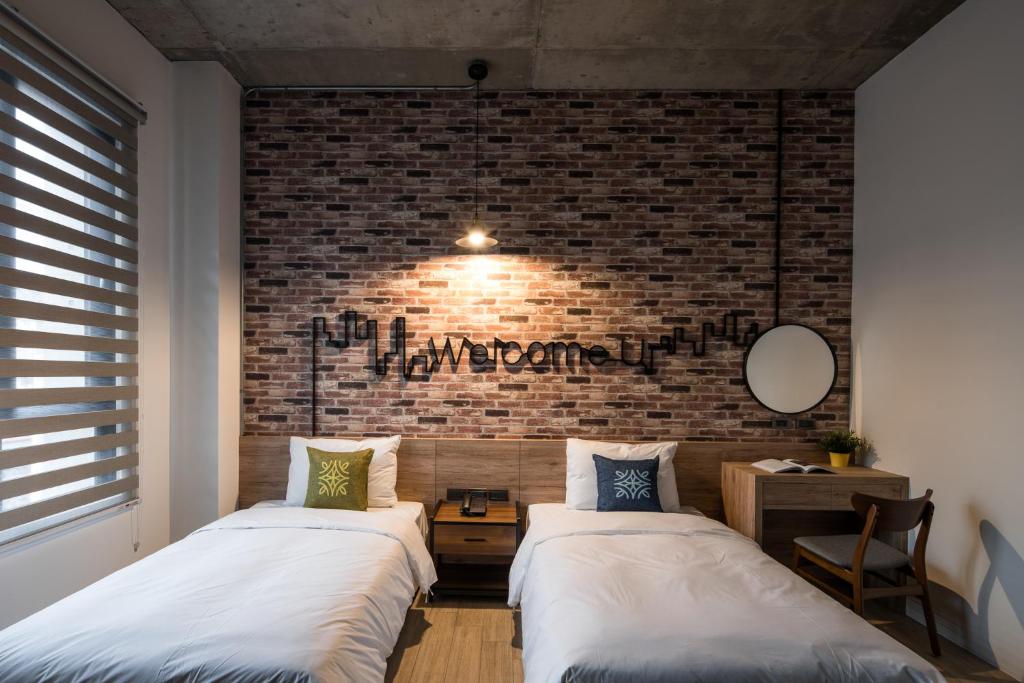 Postel nebo postele na pokoji v ubytování Tian Zhong Hotel