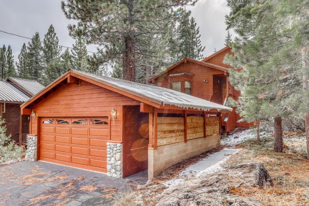 a house with a garage in the woods at Tuna Bush in Truckee