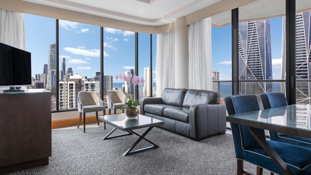 a living room with a view of a city at Oaks Gold Coast Hotel in Gold Coast