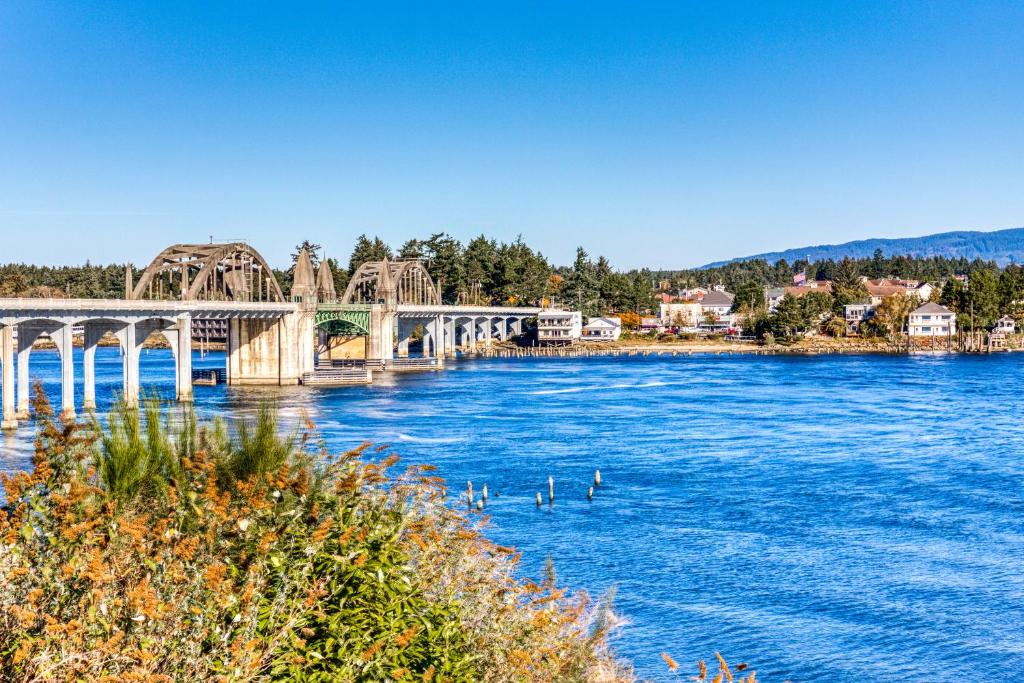 a bridge over a river with ducks in the water at River Vista in Florence