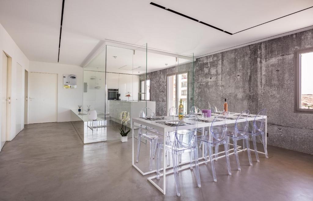 a kitchen with a table and chairs in a room at Sea Lovers Apartment in Alcudia
