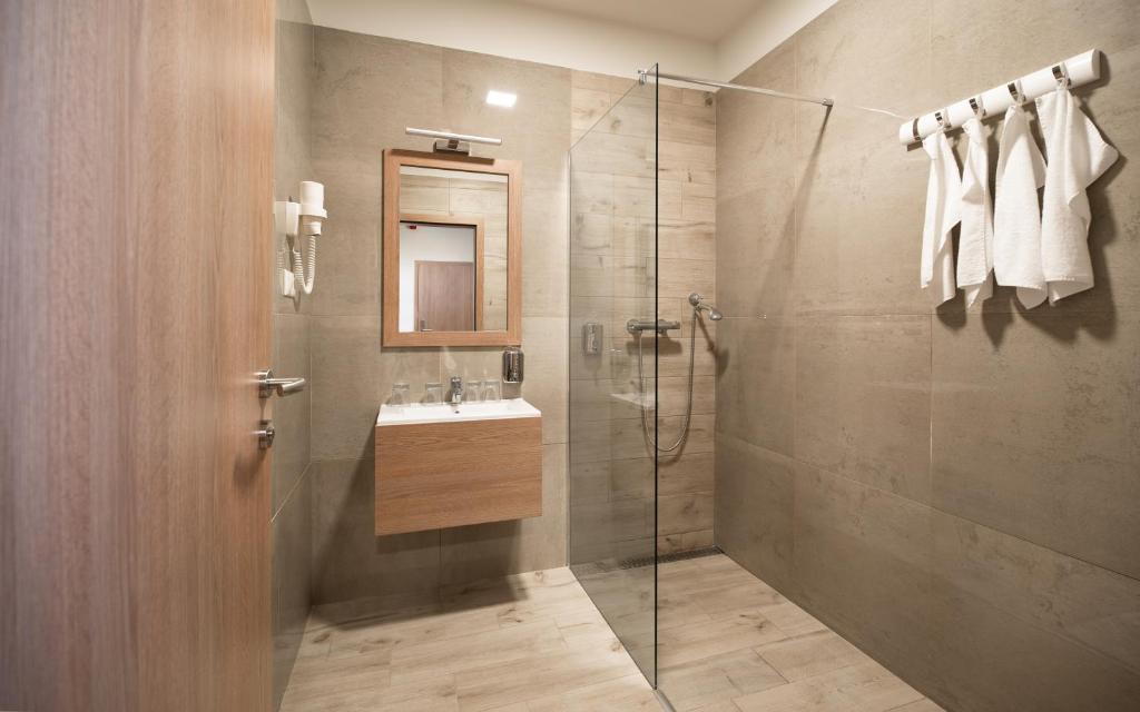 łazienka z prysznicem i umywalką w obiekcie Hotel Szeghalom w mieście Szeghalom