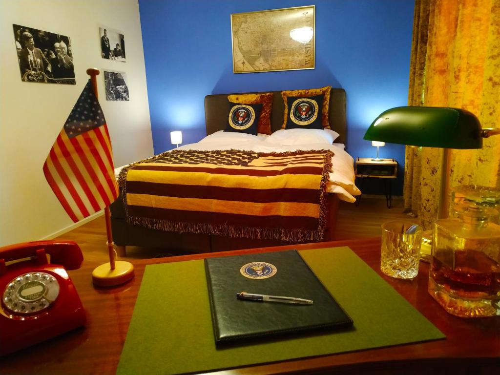 a bedroom with a bed and an american flag at Rheinland Hotel in Bonn