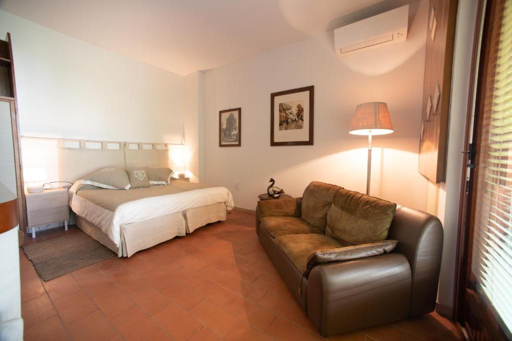 a living room with a bed and a couch at B&B Parco Antico in Somma Lombardo