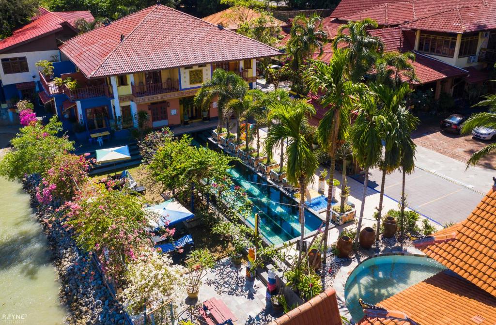 an aerial view of a resort with a swimming pool at Lost Paradise Resort in Batu Ferringhi