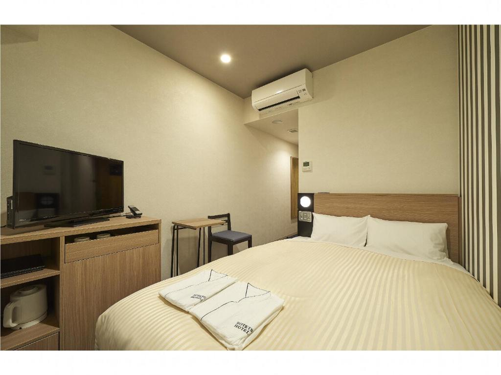 Postel nebo postele na pokoji v ubytování Sotetsu Fresa Inn Kamakura-Ofuna Higashiguchi