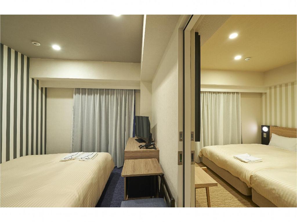 Postel nebo postele na pokoji v ubytování Sotetsu Fresa Inn Kamakura-Ofuna Higashiguchi