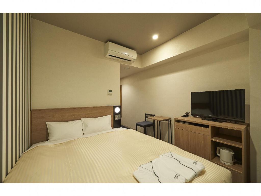 Postel nebo postele na pokoji v ubytování Sotetsu Fresa Inn Kamakura-Ofuna Higashiguchi