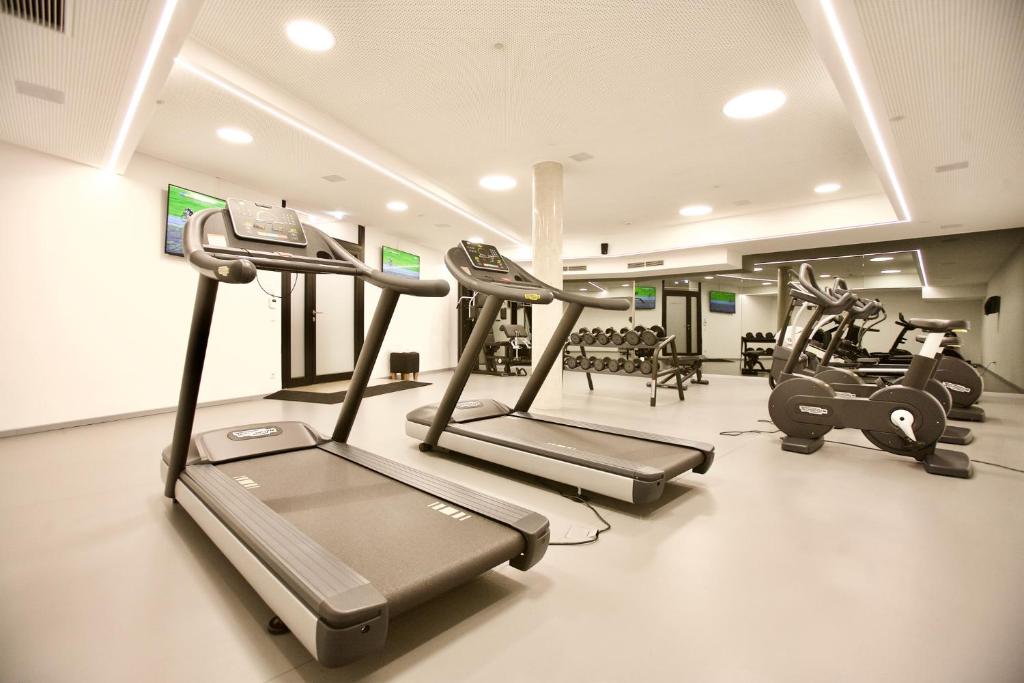 a gym with treadmills and elliptical machines at COOL MAMA Salzburg in Salzburg