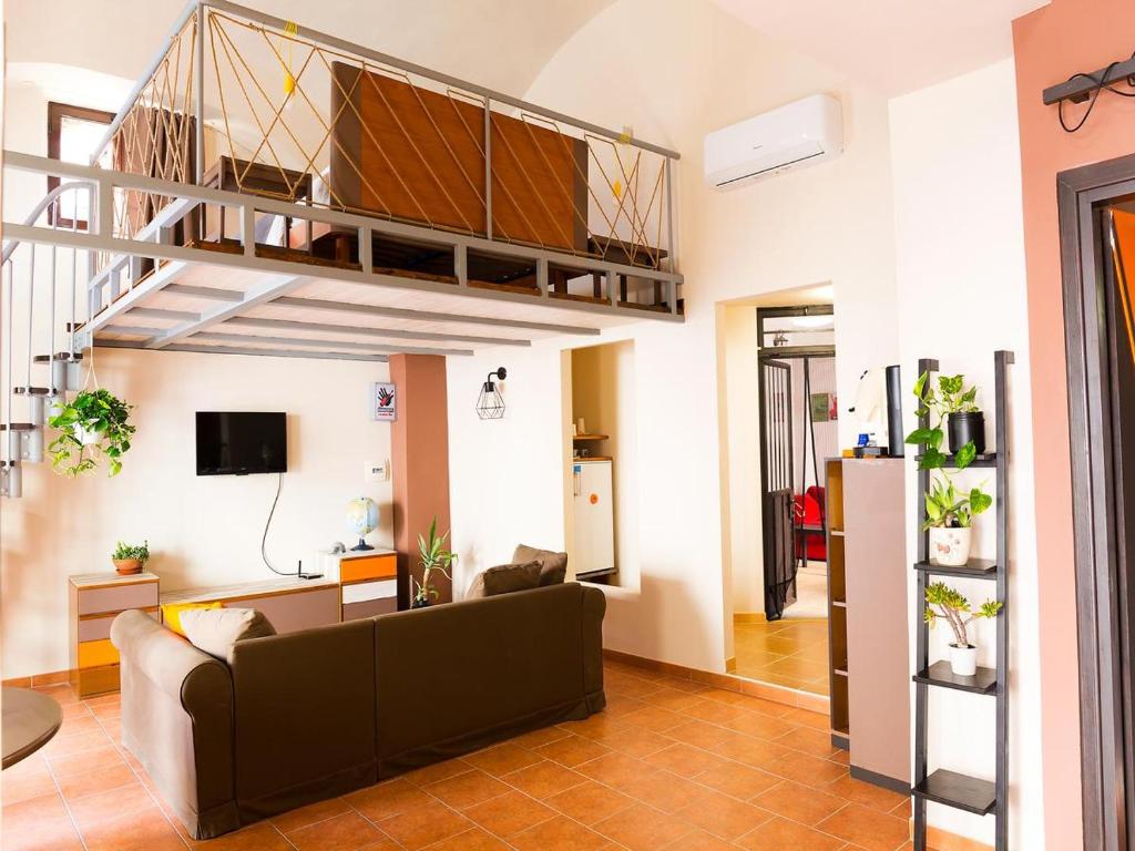 Santa Maria a Vico的住宿－Al Vicolo Stretto，带沙发的客厅和阁楼。