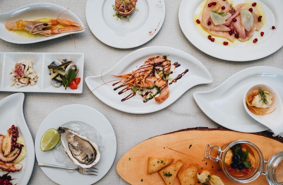 a table with plates of food on it at Hotel Corallo in Francavilla al Mare