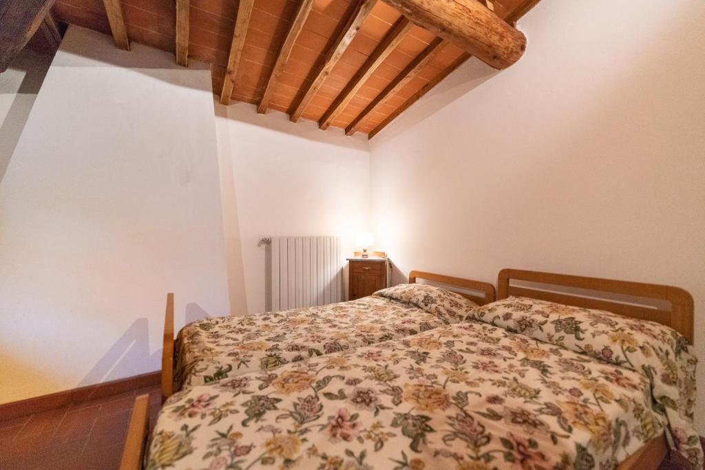 Postel nebo postele na pokoji v ubytování Fattoria di Cintoia