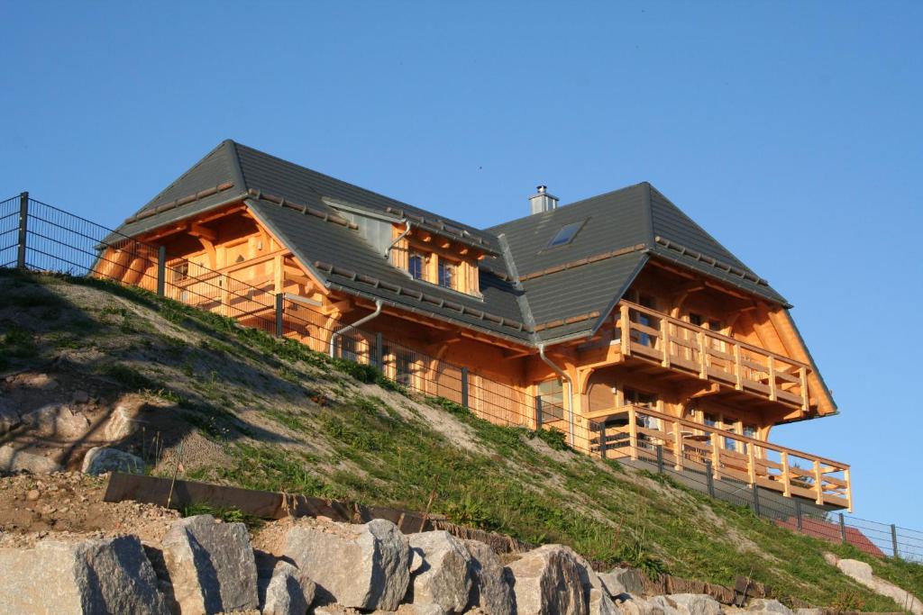 a large wooden house on top of a hill at Schwarzwaldhuus Feldberg in Feldberg