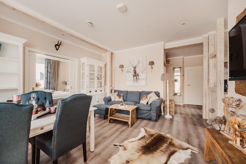 a living room with a blue couch and a table at Casa Bella Cosa in Braunlage