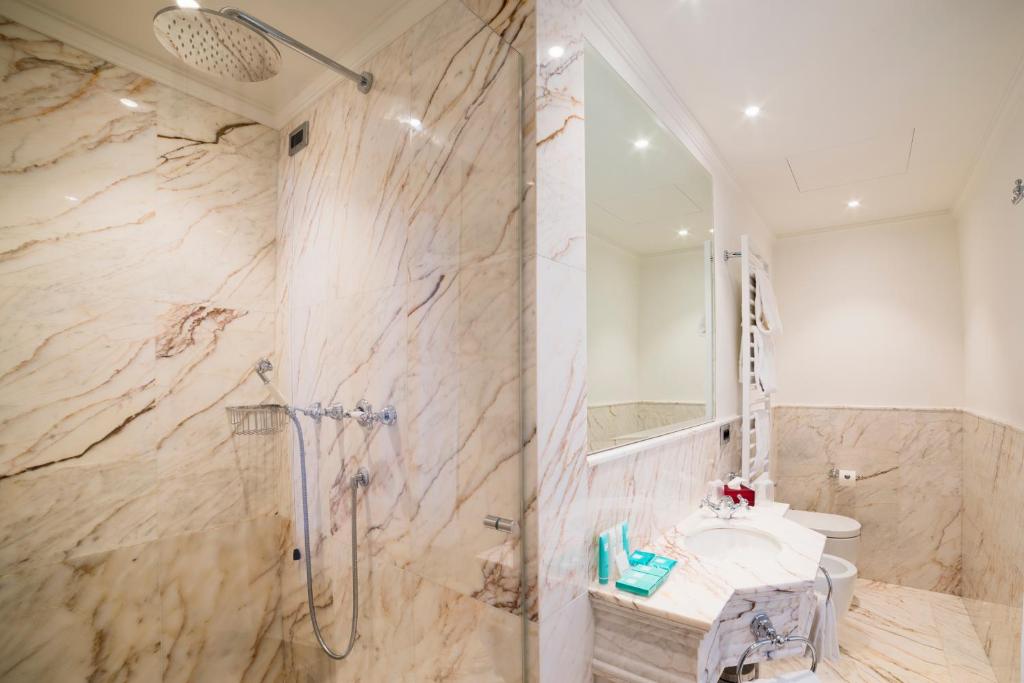 a bathroom with a sink and a shower at Hotel Nani Mocenigo Palace in Venice