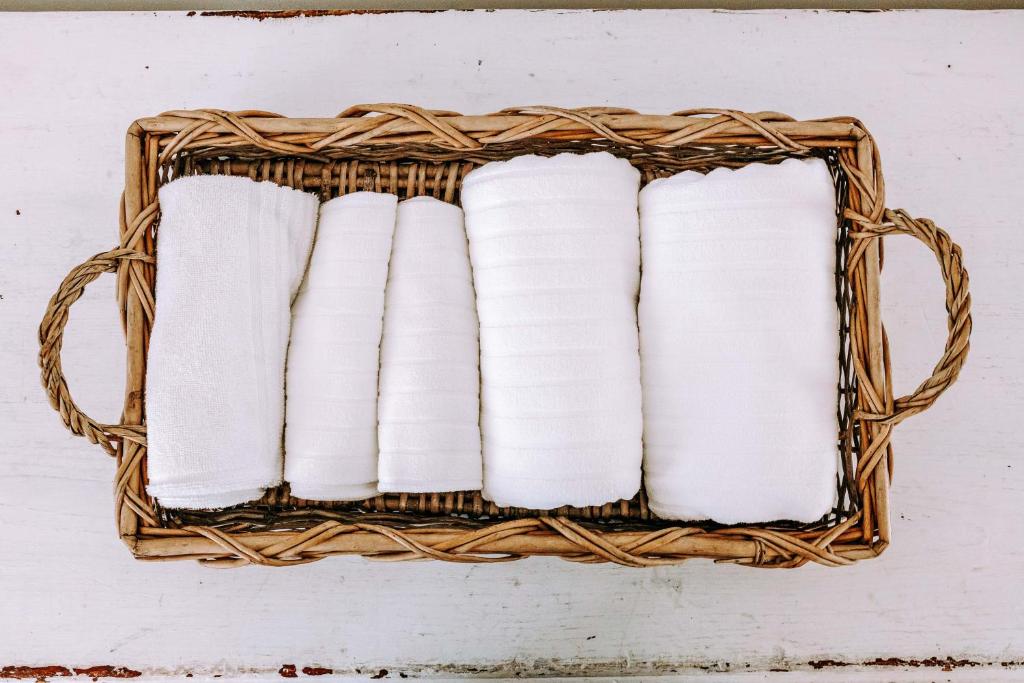 a basket of toilet paper on a white wall at Dimora Anderì in Polignano a Mare