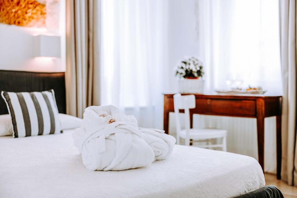 a pile of towels sitting on top of a bed at Dimora Anderì in Polignano a Mare