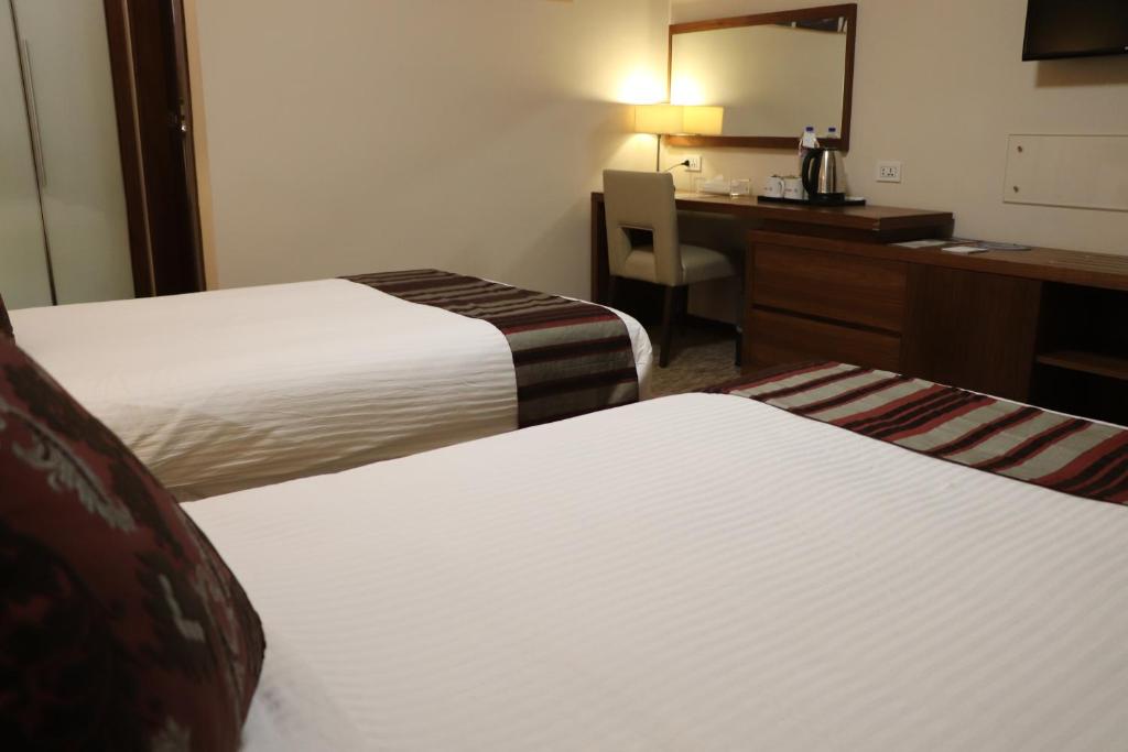 Postel nebo postele na pokoji v ubytování Mamba Point Hotel