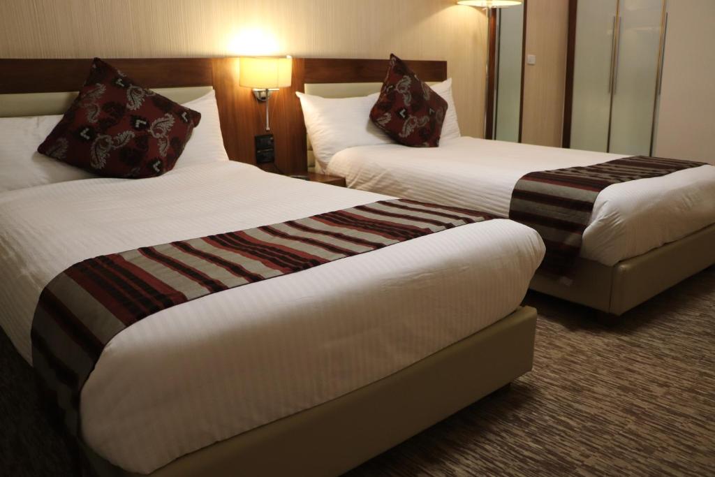 Postel nebo postele na pokoji v ubytování Mamba Point Hotel