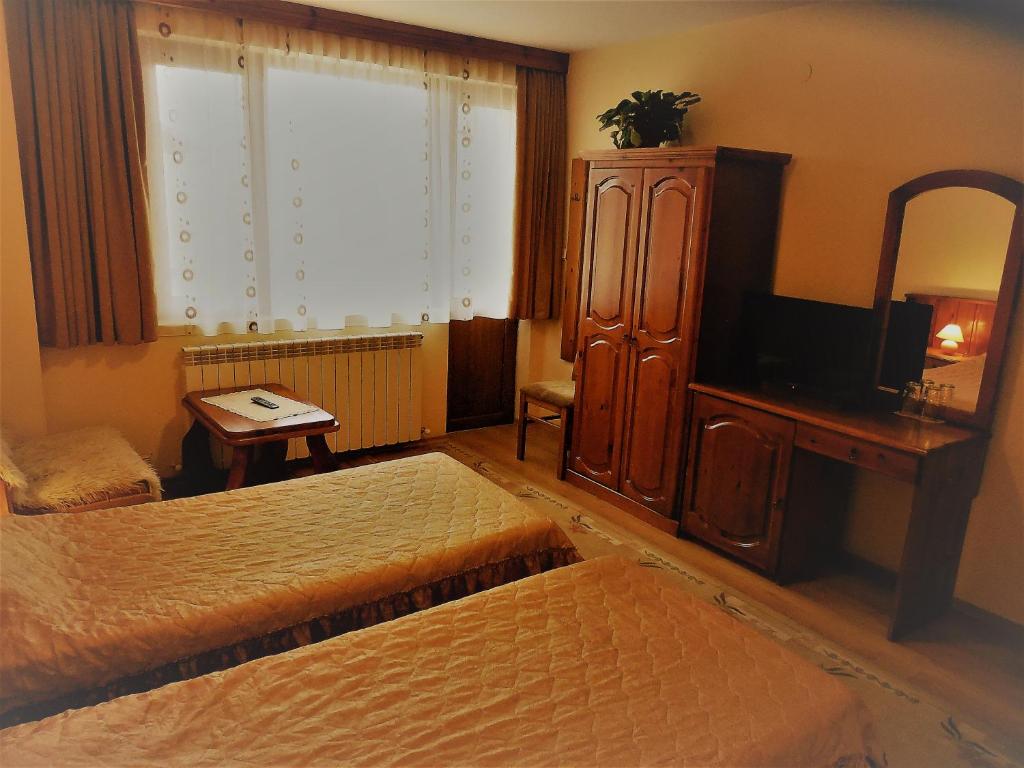 Postel nebo postele na pokoji v ubytování Boyadjiyski Guest House