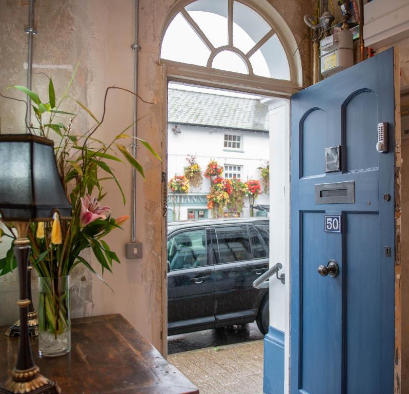a blue door with a view of a car at MAISON50 in Crickhowell