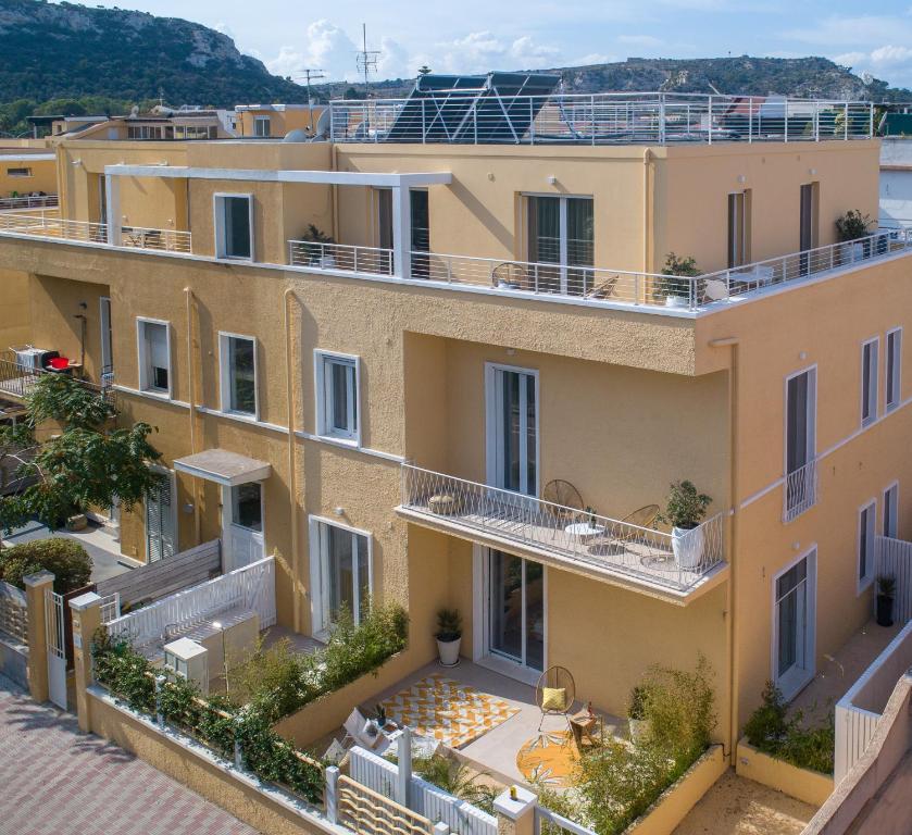 an image of an apartment building with balconies at Le Palmette Suites in Cagliari