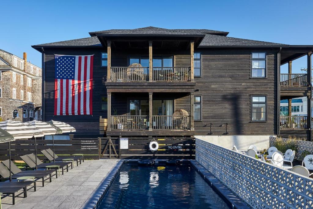 a house with a swimming pool in front of a house at Lokal Hotel Cape May in Cape May