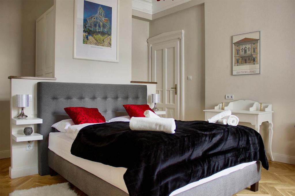 ブダペストにあるDeluxe in the heart of the cityのベッドルーム1室(大型ベッド1台、赤い枕付)