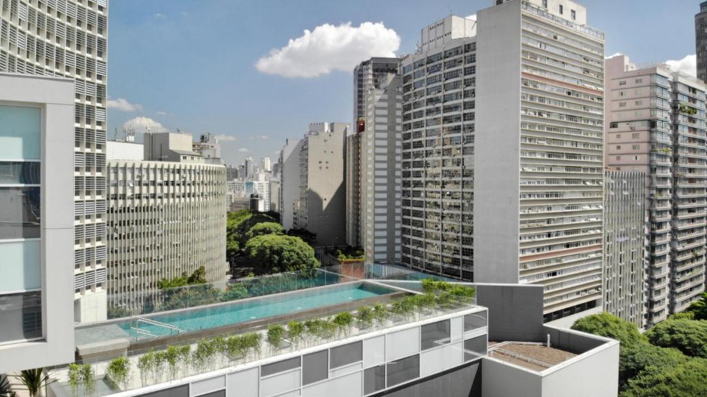 an apartment with a swimming pool on the roof of a building at 360 São Luis in Sao Paulo