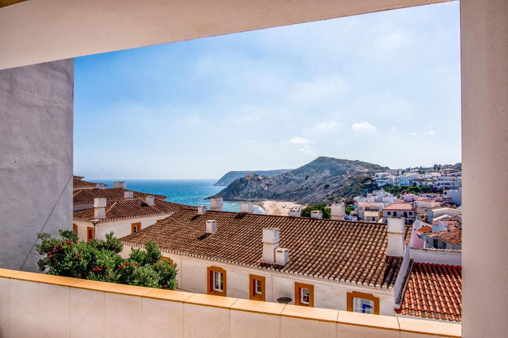 
a view from a balcony of a building with a view of the ocean at Hotel Burgau Turismo de Natureza in Burgau
