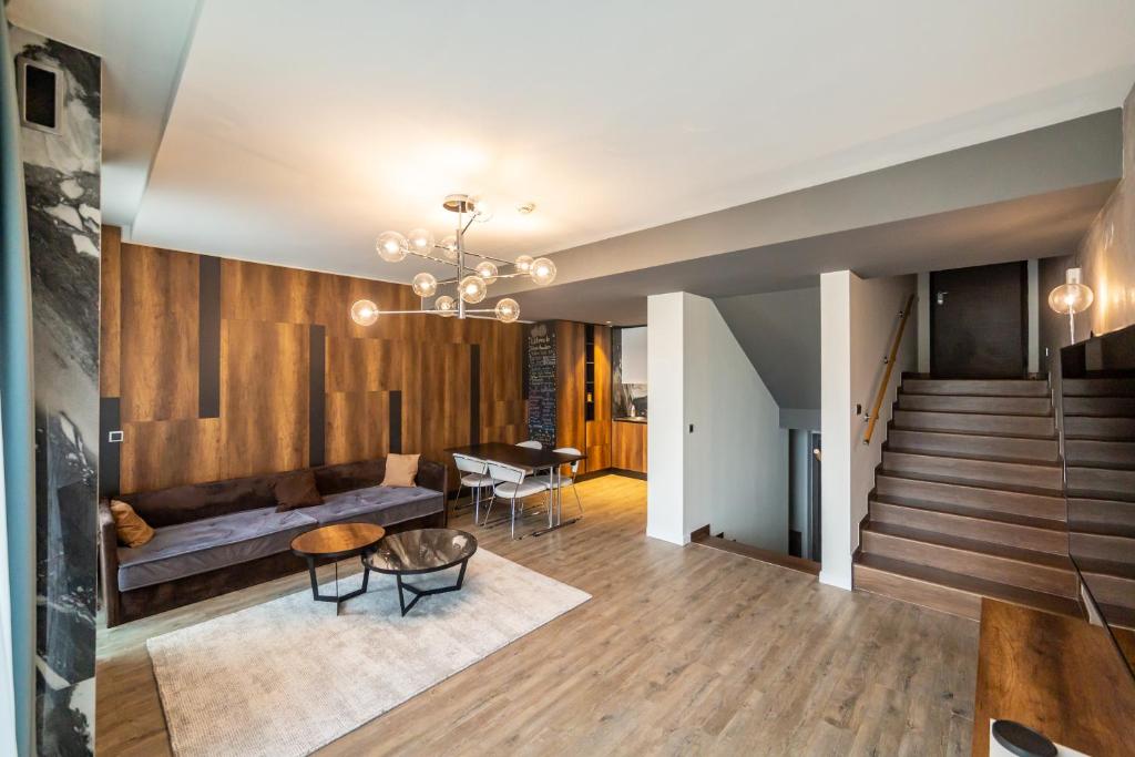 a living room with a couch and a table at Floriday Luxury Apartment in Silver Mountain in Poiana Brasov