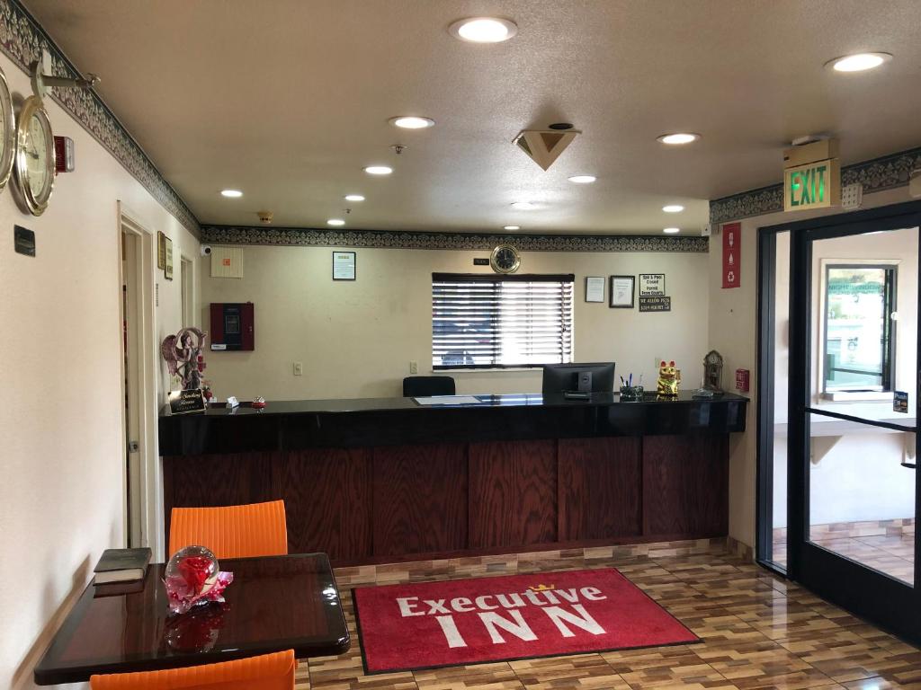 an office with a waiting inn sign on the floor at Executive Inn westley,CA in Westley