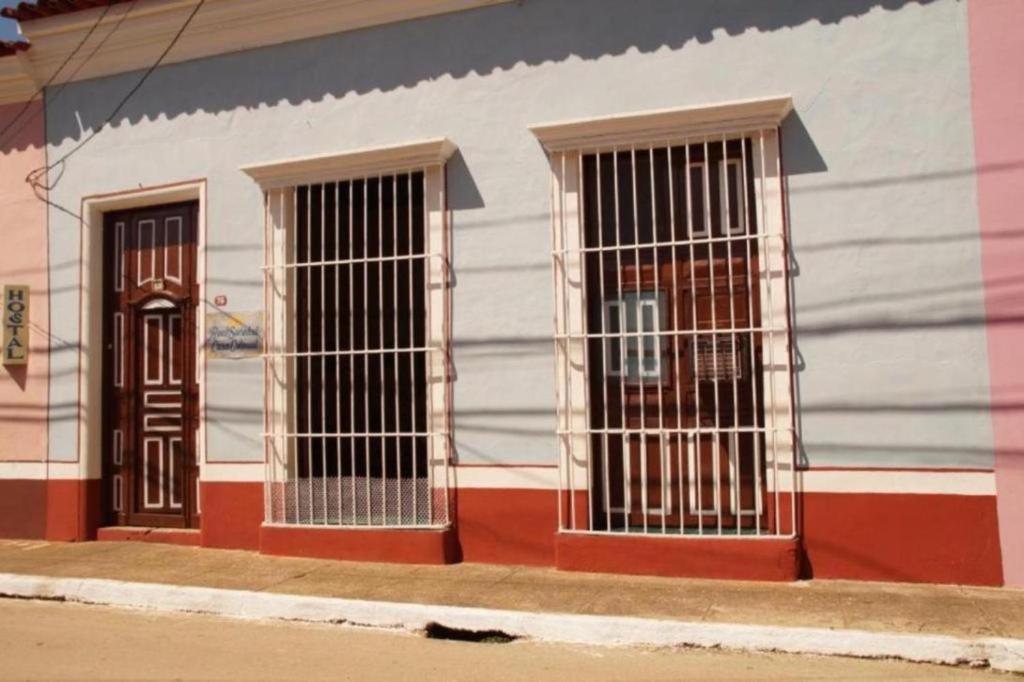 three barred windows on the side of a building at Real Sociedad in Remedios