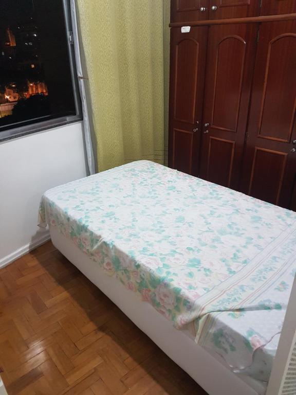 a small bed in a room with a window at Kitnet in Rio de Janeiro