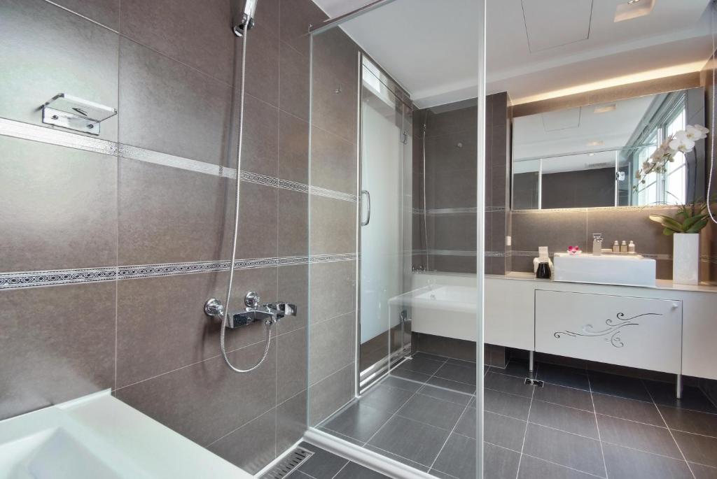 a bathroom with a shower and a sink at Forward Hotel Taipei Nangang in Taipei