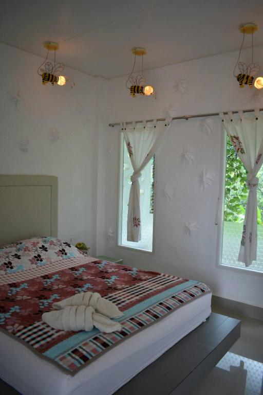 Postel nebo postele na pokoji v ubytování Rai Win Resort