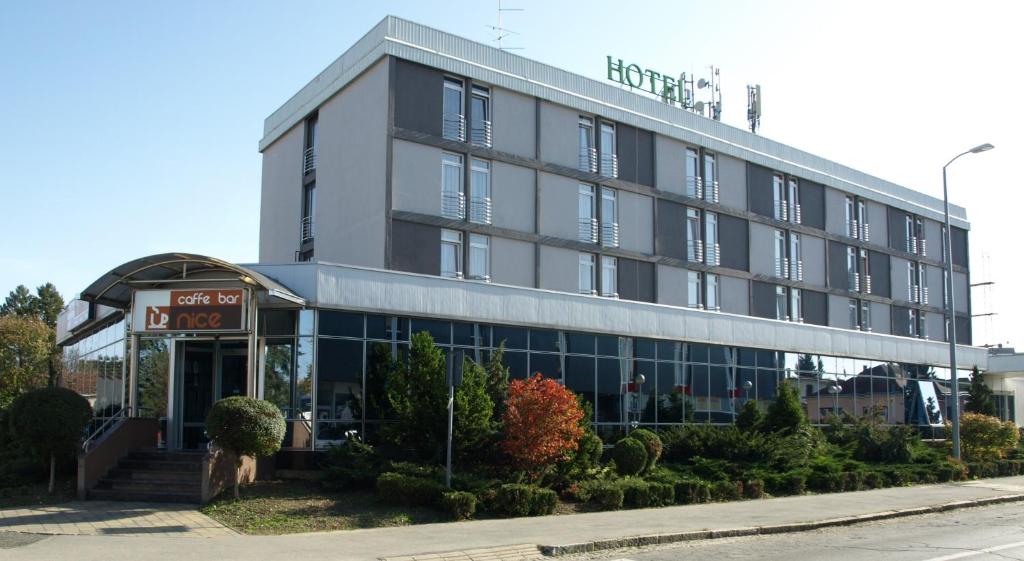 a hotel building with a sign in front of it at Hotel Podravina in Koprivnica