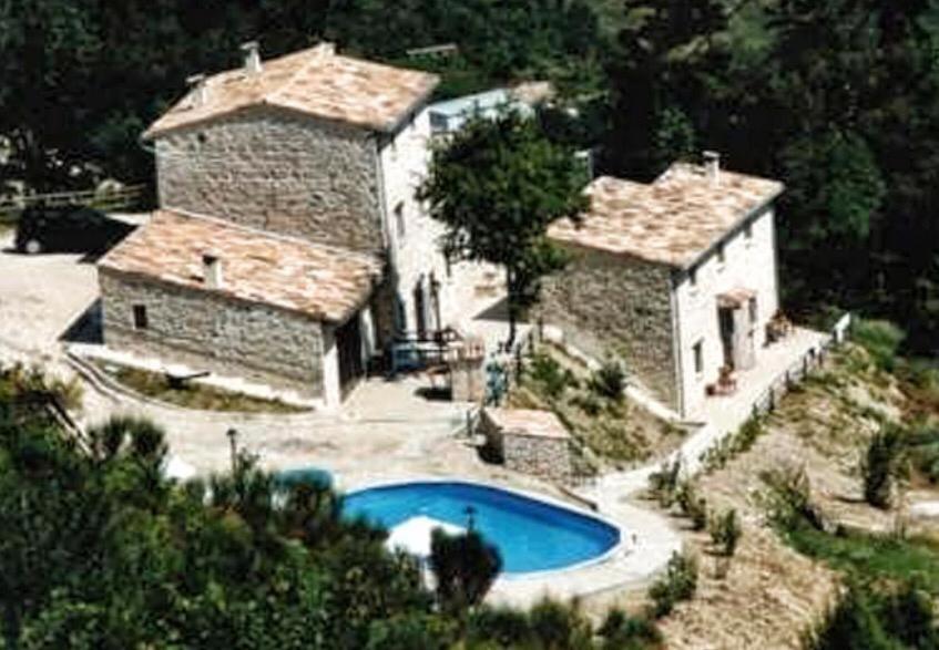 a house with a swimming pool in front of it at I Casali del Buontempo in Buggiano
