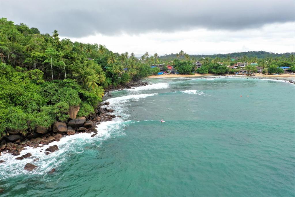 an aerial view of a river next to a beach at Surf Bar Mirissa in Mirissa