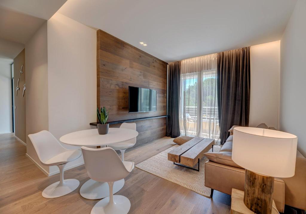 a living room with a table and a couch at Arveskida Suite Apartment in Cagliari