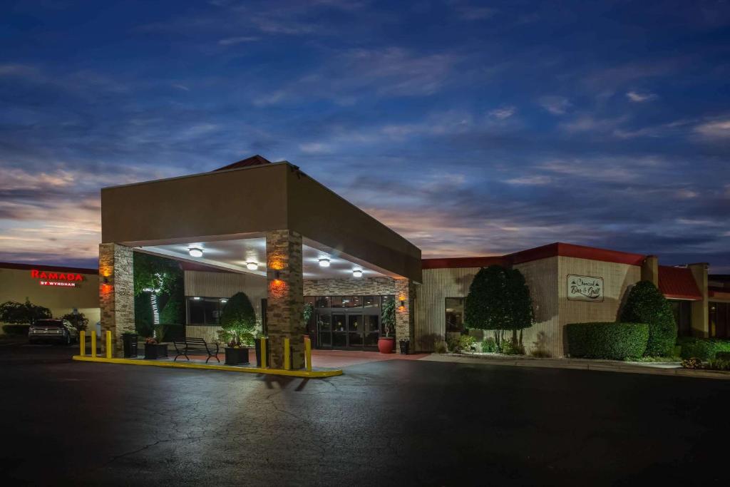 a building with a parking lot in the night at Ramada by Wyndham Statesville in Statesville