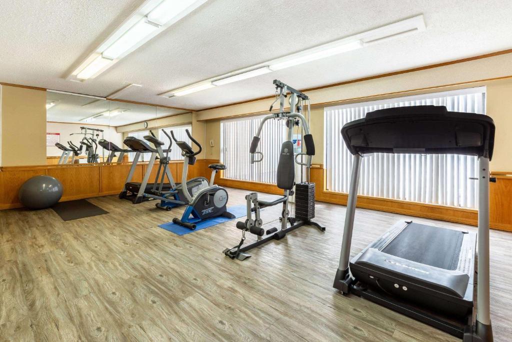 a gym with several treadmills and cardio machines at Ramada by Wyndham Coquitlam in Coquitlam