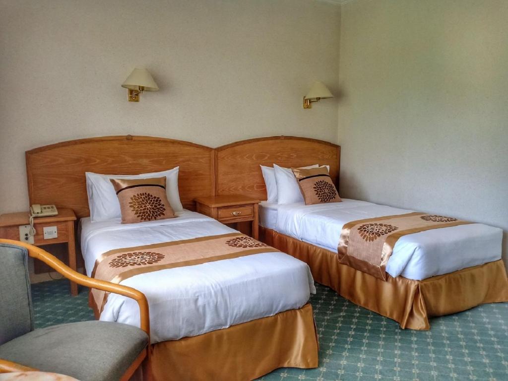 Postel nebo postele na pokoji v ubytování Terrace Hotel