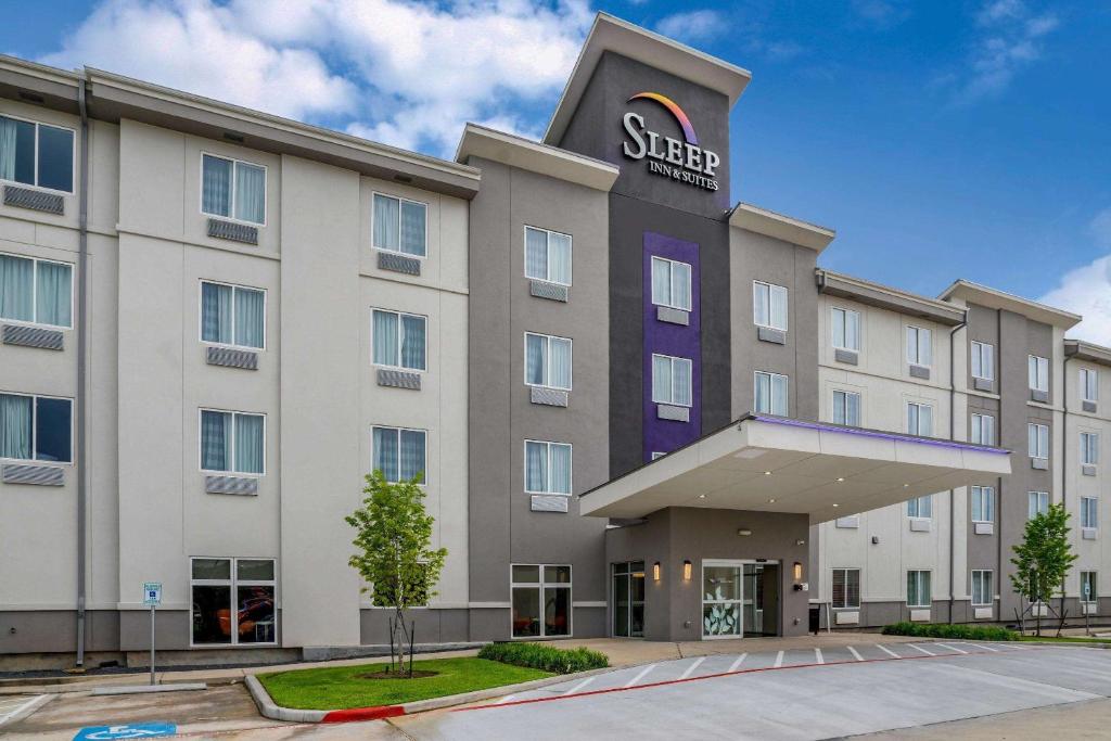 a building with a sign on the front of it at Sleep Inn & Suites near Westchase in Houston