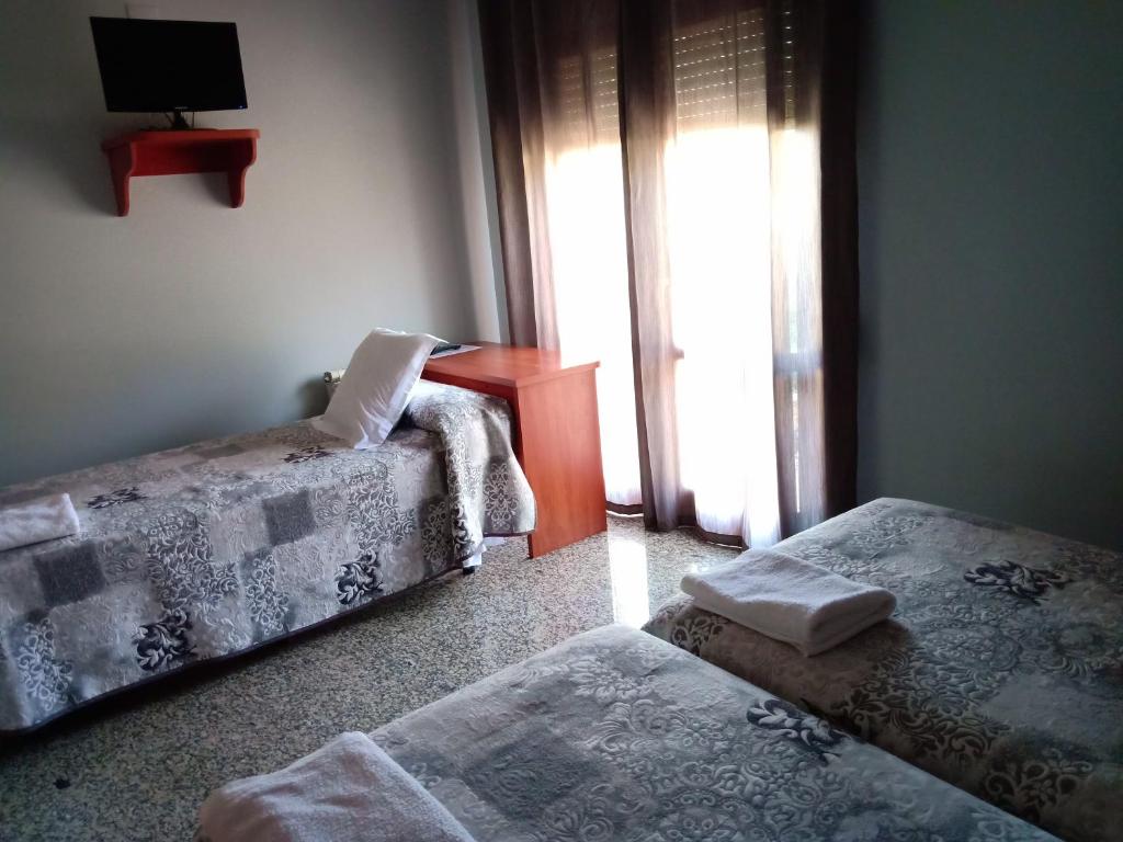 Postel nebo postele na pokoji v ubytování Hostal Casa Barranco